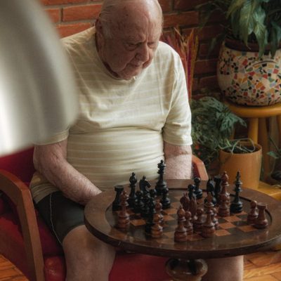 pexels-rafael-souza-2149835472-31281526 Elderly Man Playing Chess in Cozy Room representation of importance of brain games